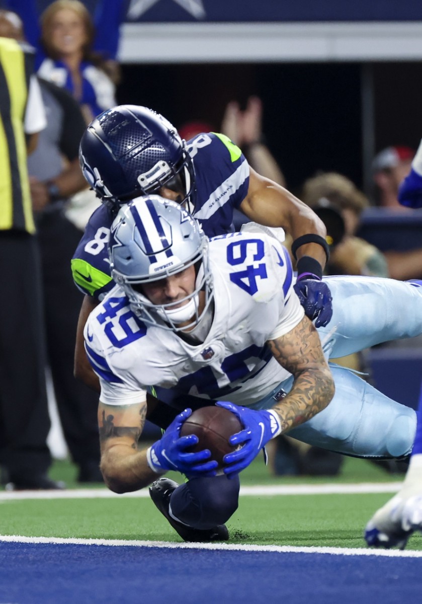 Dallas Cowboys tight end Peyton Hendershot (49) scores a touchdown during the fourth quarter against the Seattle Seahawks at AT&T Stadium.