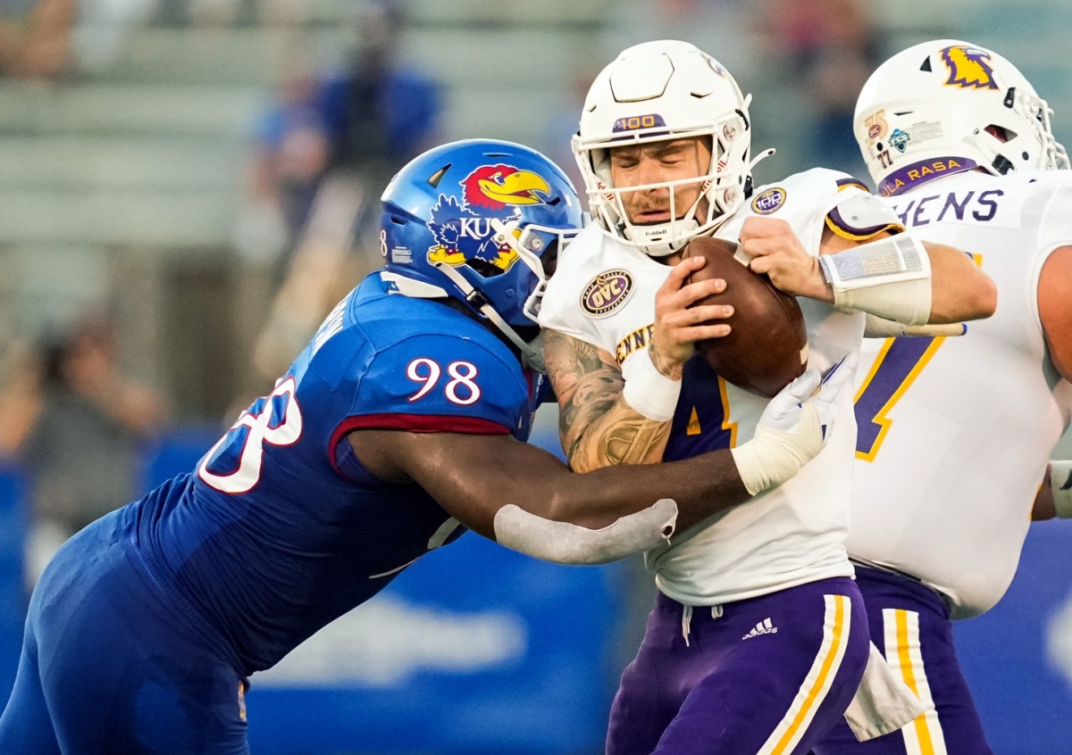 Sep 2, 2022; Lawrence, Kansas, USA; Tennessee Tech Golden Eagles quarterback Jeremiah Oatsvall (4) is sacked by Kansas Jayhawks defensive lineman Caleb Sampson (98) during the first half at David Booth Kansas Memorial Stadium.