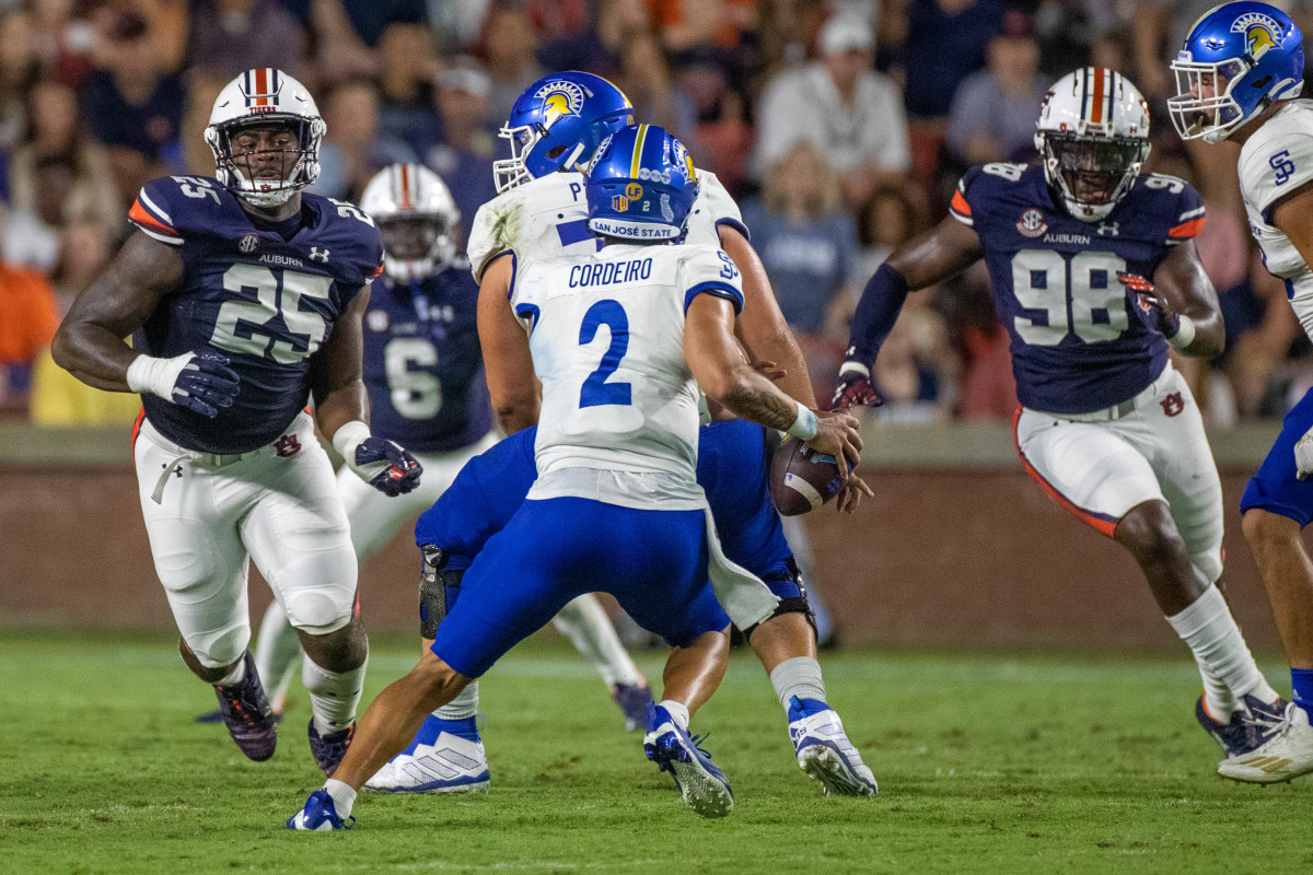 Auburn Tigers defensive end Colby Wooden (25) and  defensive end Marcus Bragg (98) bear down on San Jose State Spartans quarterback Chevan Cordeiro (2) during the San Jose State vs Auburn game on Saturday, Sept. 10, 2022.