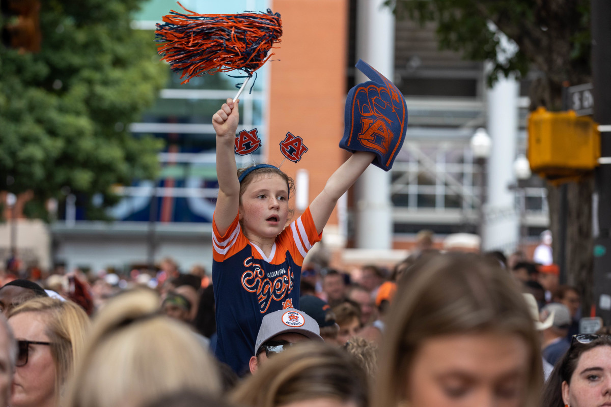 A young Auburn Tigers fan cheers on the team during the Tiger Walk prior to the San Jose State vs Auburn game on Saturday, Sept. 10, 2022.