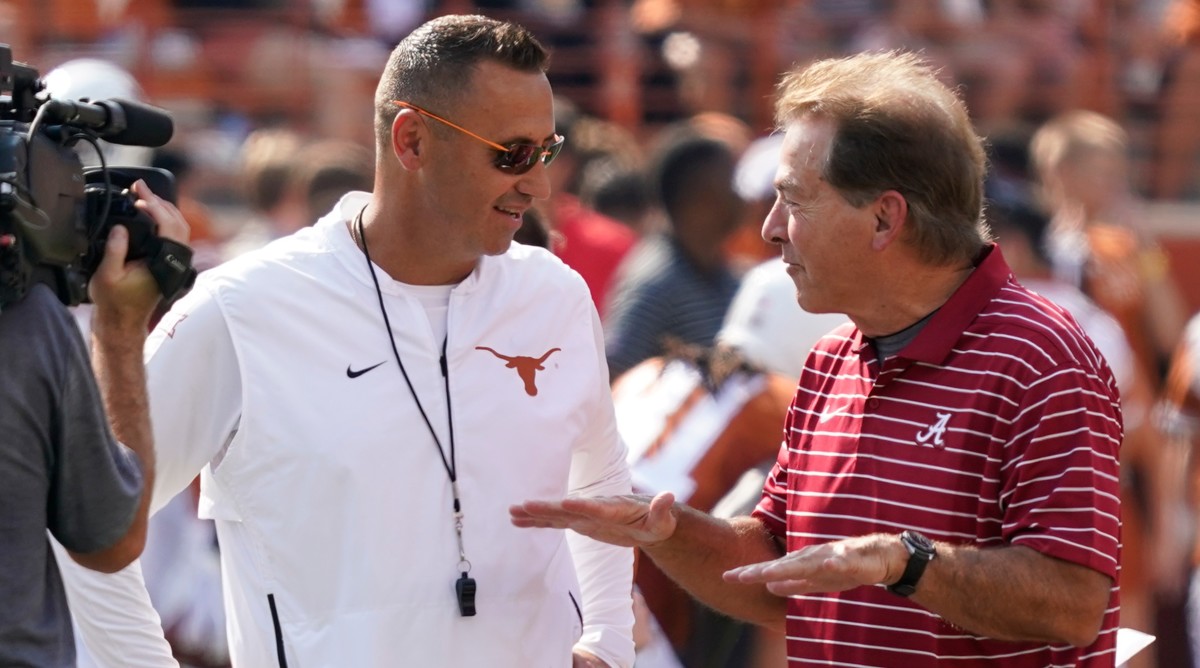 Texas Longhorns head coach Steve Sarkisian talks with Alabama Crimson Tide head coach Nick Saban before a game between the two teams.