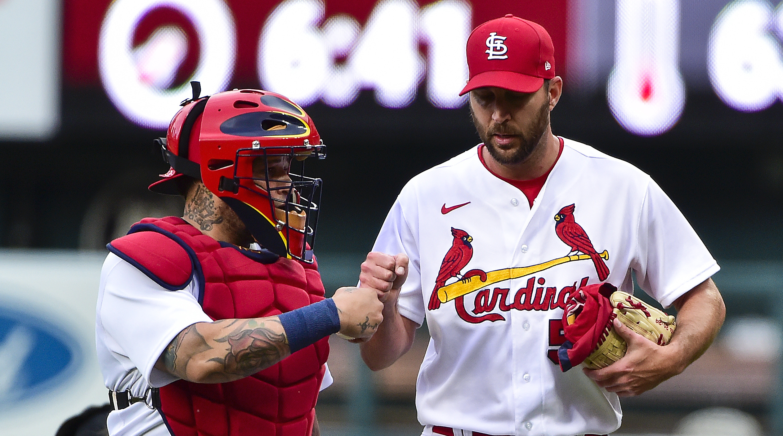 St. Louis Cardinals starting pitcher Adam Wainwright (R) bumps fists with  catcher Yadier Molina as they walk in from the bullpen before a game  against the Washington Nationals at Busch Stadium in