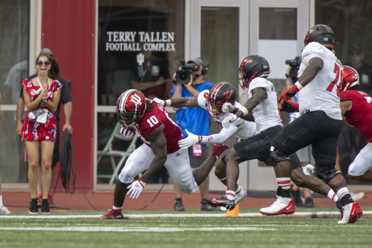 Indiana Hoosiers linebacker Myles Jackson (10) is tackled by Western Kentucky Hilltoppers wide receiver Jaylen Hall (0) after intercepting the ball during the second half at Memorial Stadium. Hoosiers won 33 to 30 in overtime.