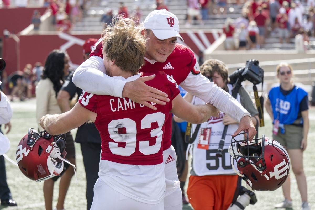 Indiana Hoosiers place kicker Charles Campbell (93) shares a moment with Indiana Hoosiers quarterback Connor Bazelak (9) after kicking the game winning field goal in extra time after the game against the Western Kentucky Hilltoppers at Memorial Stadium. Hoosiers won 33 to 30 in overtime.