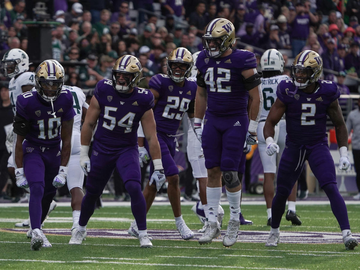 Davon Banks (10) is surrounded by teammates Drew Fowler, Julius Irvin, Carson Bruener and Cam Bright after leveling a Michigan State kicker returner.