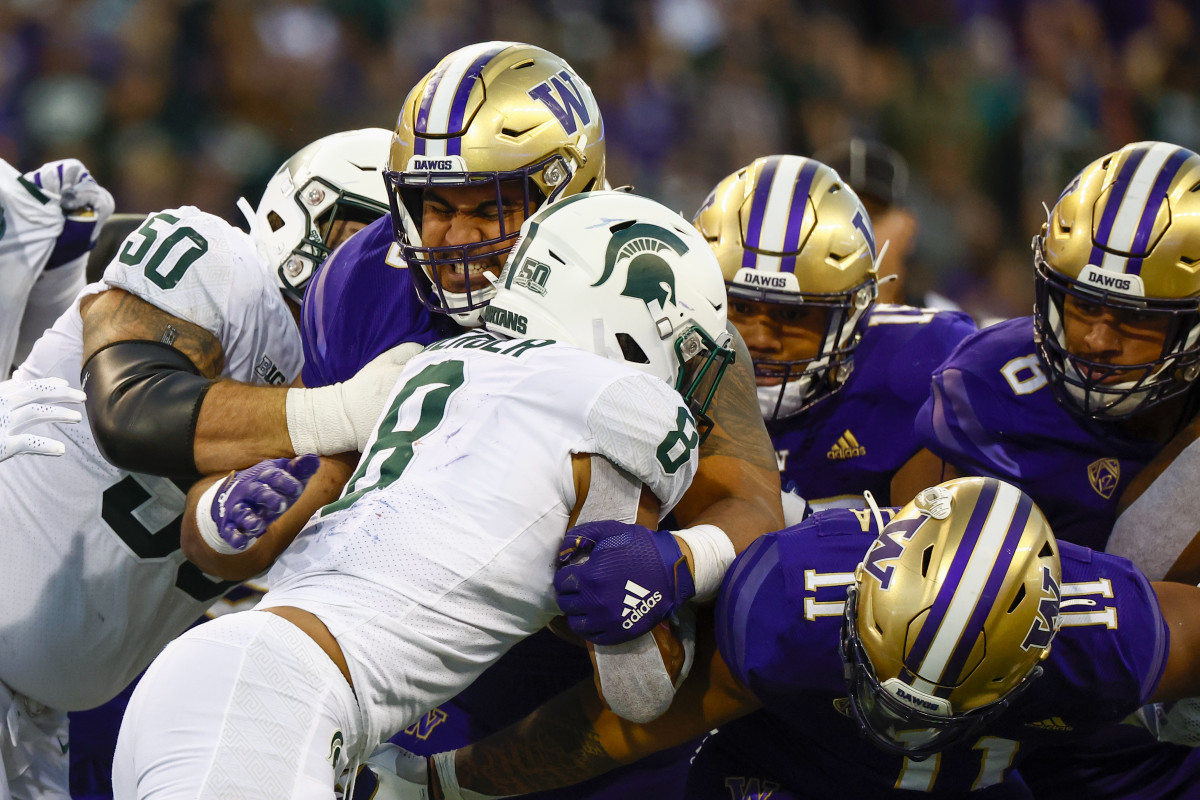 Washington Huskies defensive lineman Voi Tunuufi (90) tackles Michigan State Spartans running back Jalen Berger (8) during the third quarter at Alaska Airlines Field at Husky Stadium.