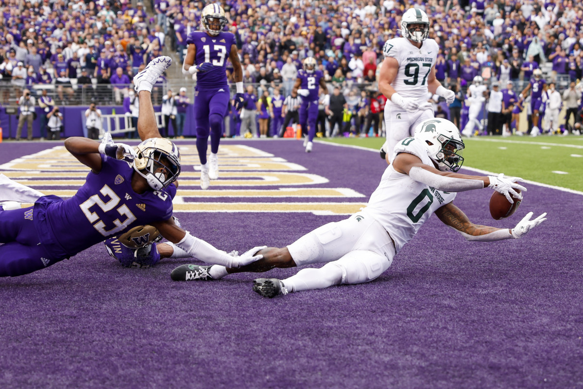 Michigan State Spartans wide receiver Keon Coleman (0) catches a touchdown pass against the Washington Huskies during the second quarter at Alaska Airlines Field at Husky Stadium.