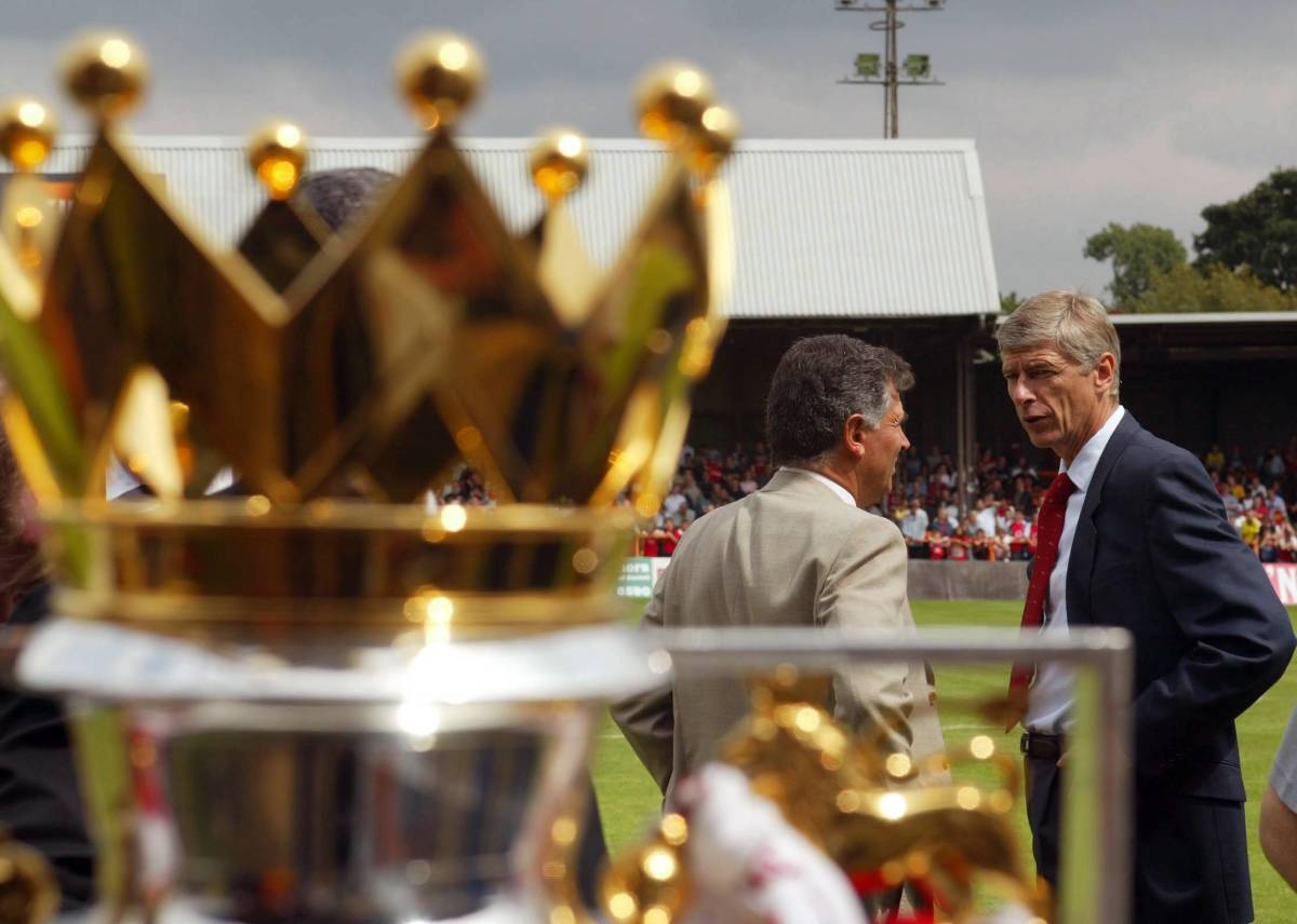 Arsene Wenger pictured (right) in 2004 in the presence of the Premier League trophy