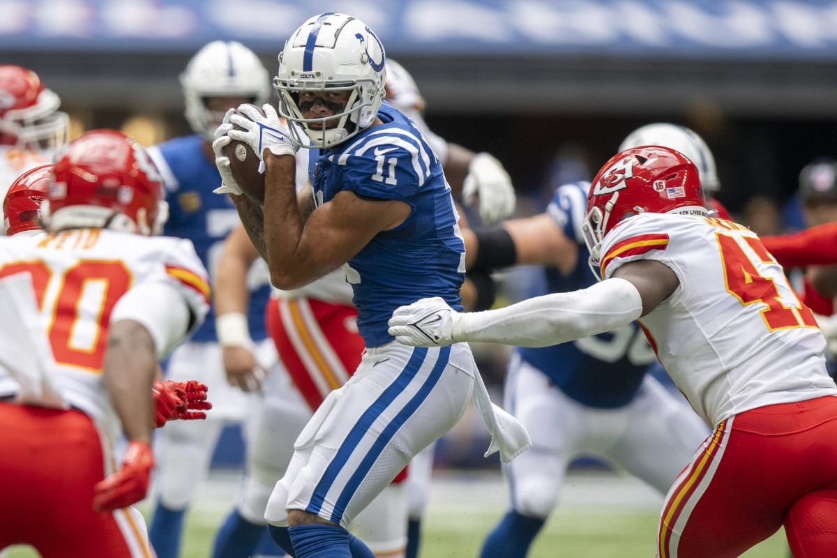 Sep 25, 2022; Indianapolis, Indiana, USA; Indianapolis Colts wide receiver Michael Pittman Jr. (11) catches a pass in front of Kansas City Chiefs linebacker Darius Harris (47) during the second quarter at Lucas Oil Stadium.