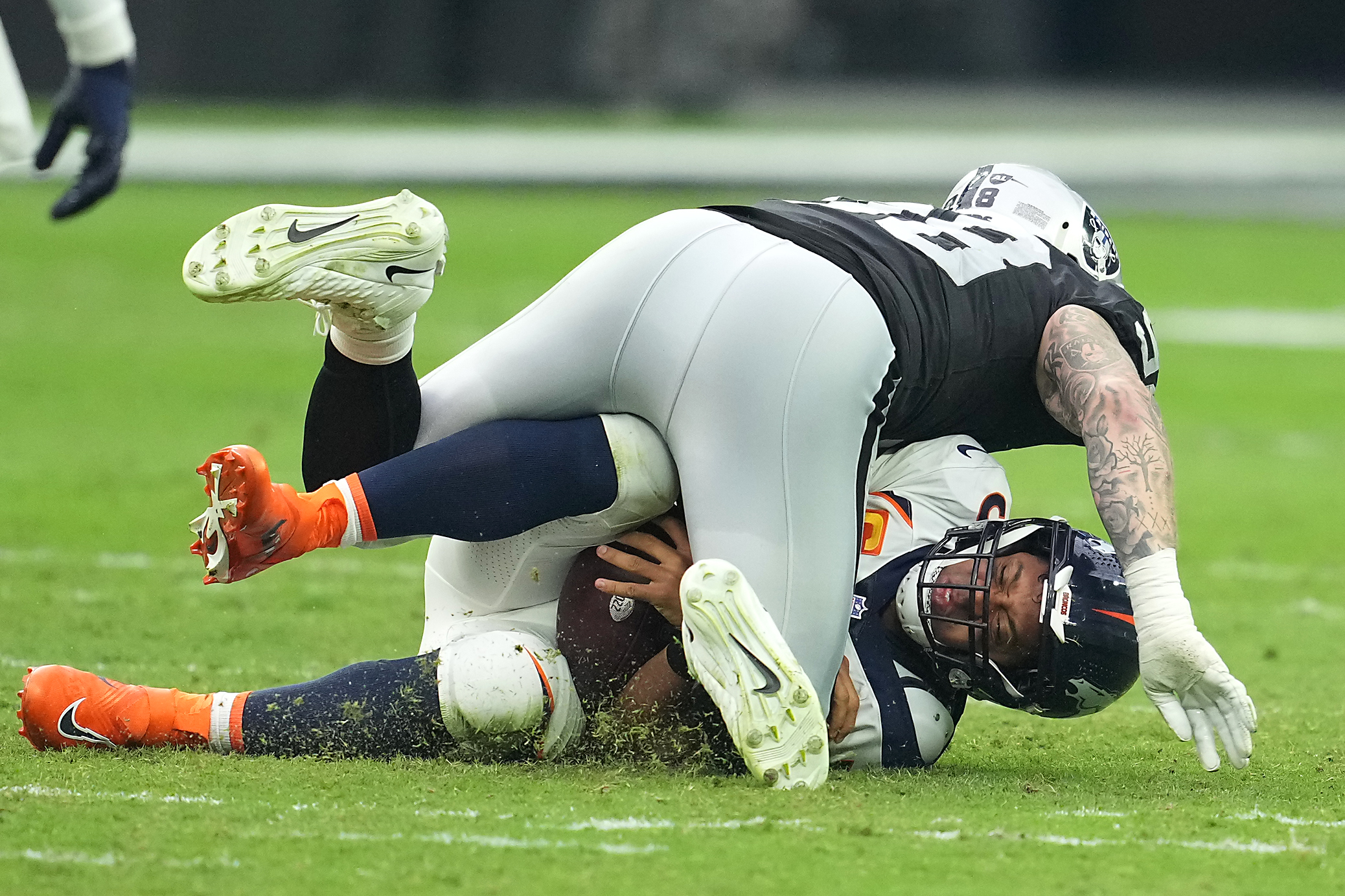 Denver Broncos quarterback Russell Wilson (3) is tackled by Indianapolis  Colts defensive tackle DeForest Buckner (99)