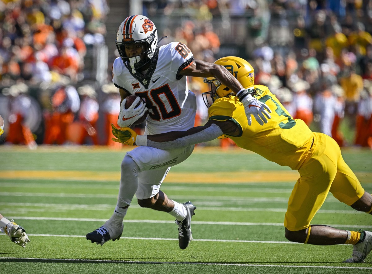 Oklahoma State Cowboys wide receiver Brennan Presley (80) tries to elude the tackle of Baylor Bears cornerback Mark Milton (3) during the second quarter at McLane Stadium