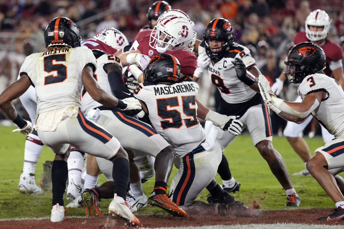 Stanford Cardinal running back Casey Filkins (2, center) scores a touchdown against Oregon State Beavers linebacker Easton Mascarenas-Arnold (55) during the first quarter at Stanford Stadium.