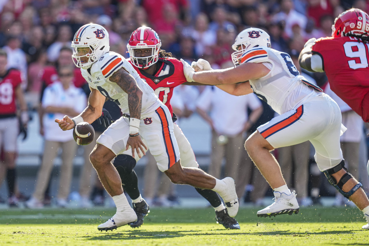 Oct 8, 2022; Athens, Georgia, USA; Auburn Tigers quarterback Robby Ashford (9) fumbles the ball against the Georgia Bulldogs during the first half at Sanford Stadium. Mandatory Credit: Dale Zanine-USA TODAY Sports