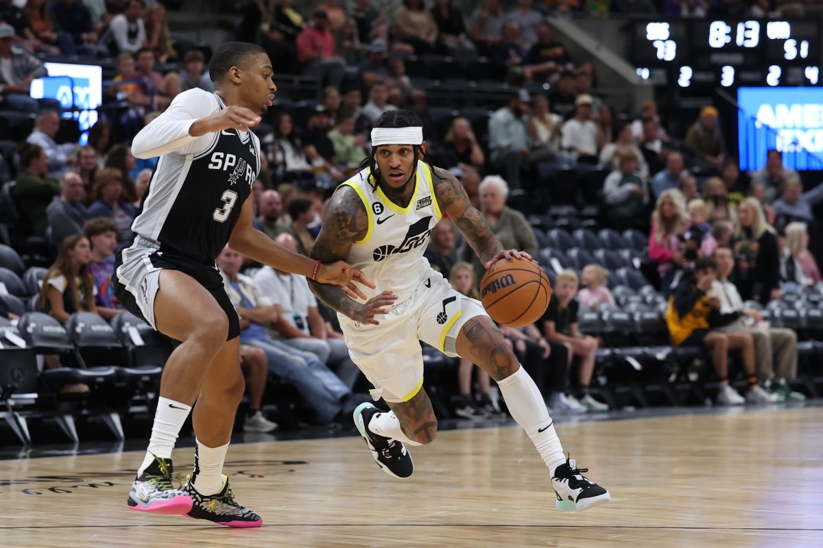 Utah Jazz guard Jordan Clarkson (00) drives the all past San Antonio Spurs forward Keldon Johnson (3) in the third quarter at Vivint Arena.