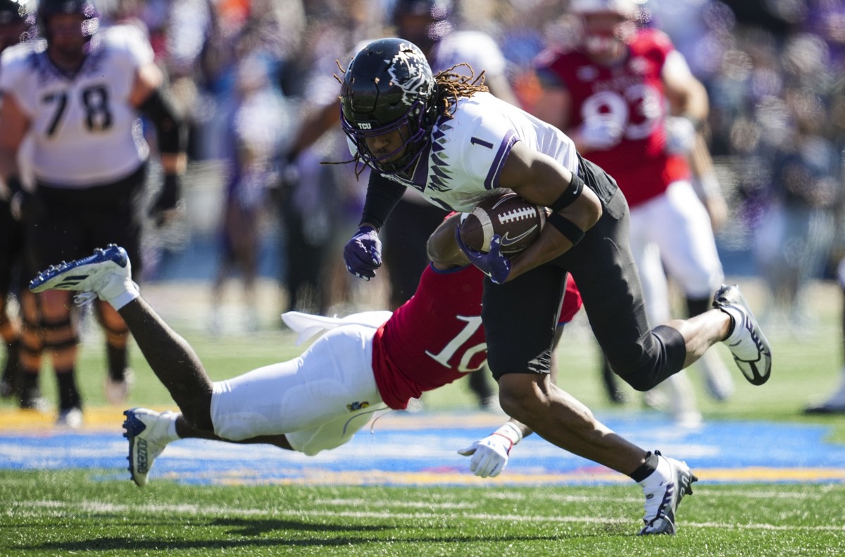 Oct 8, 2022; Lawrence, Kansas, USA; TCU Horned Frogs wide receiver Quentin Johnston (1) runs with the ball against Kansas Jayhawks safety Jayson Gilliom (10) during the second half at David Booth Kansas Memorial Stadium.