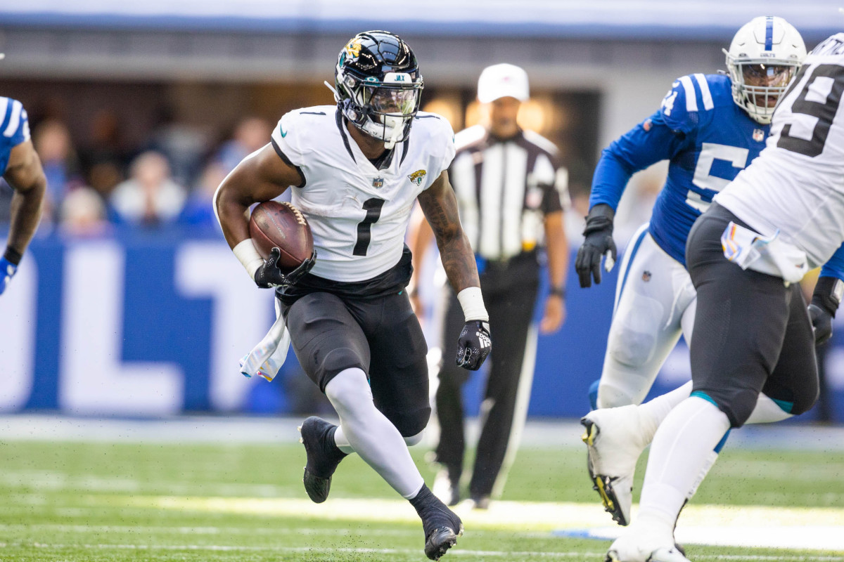 Oct 16, 2022; Indianapolis, Indiana, USA; Jacksonville Jaguars running back Travis Etienne Jr. (1) runs the ball in the first quarter against the Indianapolis Colts at Lucas Oil Stadium.