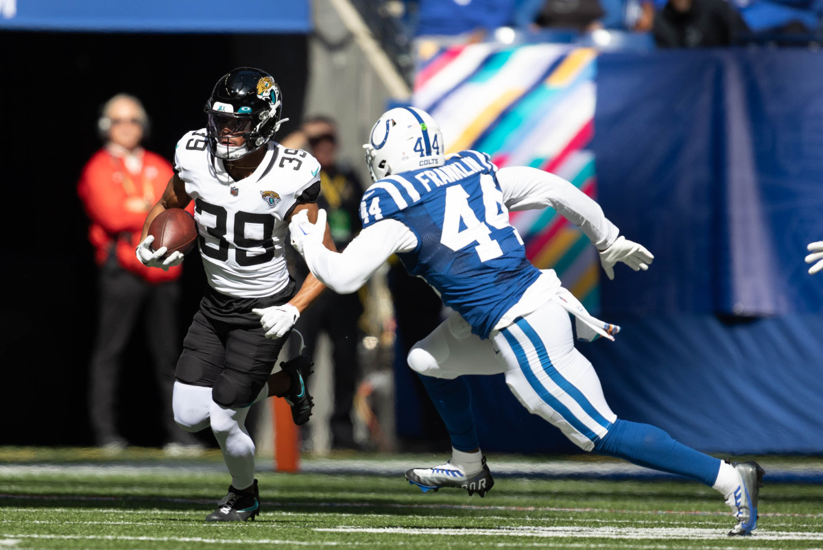 Oct 16, 2022; Indianapolis, Indiana, USA; Jacksonville Jaguars wide receiver Jamal Agnew (39) runs the ball while Indianapolis Colts linebacker Zaire Franklin (44) defends in the second quarter at Lucas Oil Stadium.