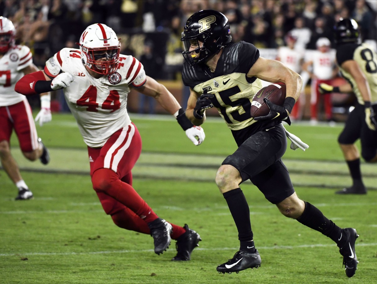 Oct 15, 2022; West Lafayette, Indiana, USA; Purdue Boilermakers wide receiver Charlie Jones (15) runs after a catch past Nebraska Cornhuskers defensive end Garrett Nelson (44) during the second half at Ross-Ade Stadium.