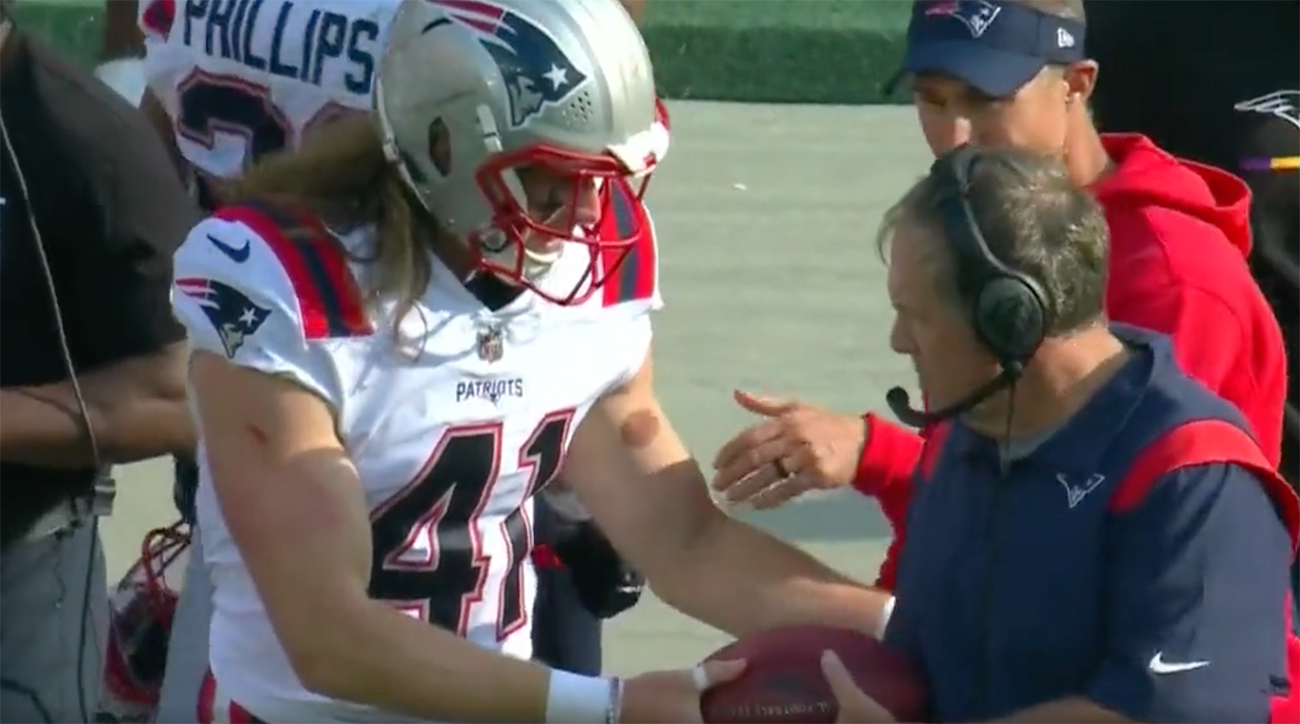 Patriots rookie Brenden Schooler tries to give football to Bill Belichick