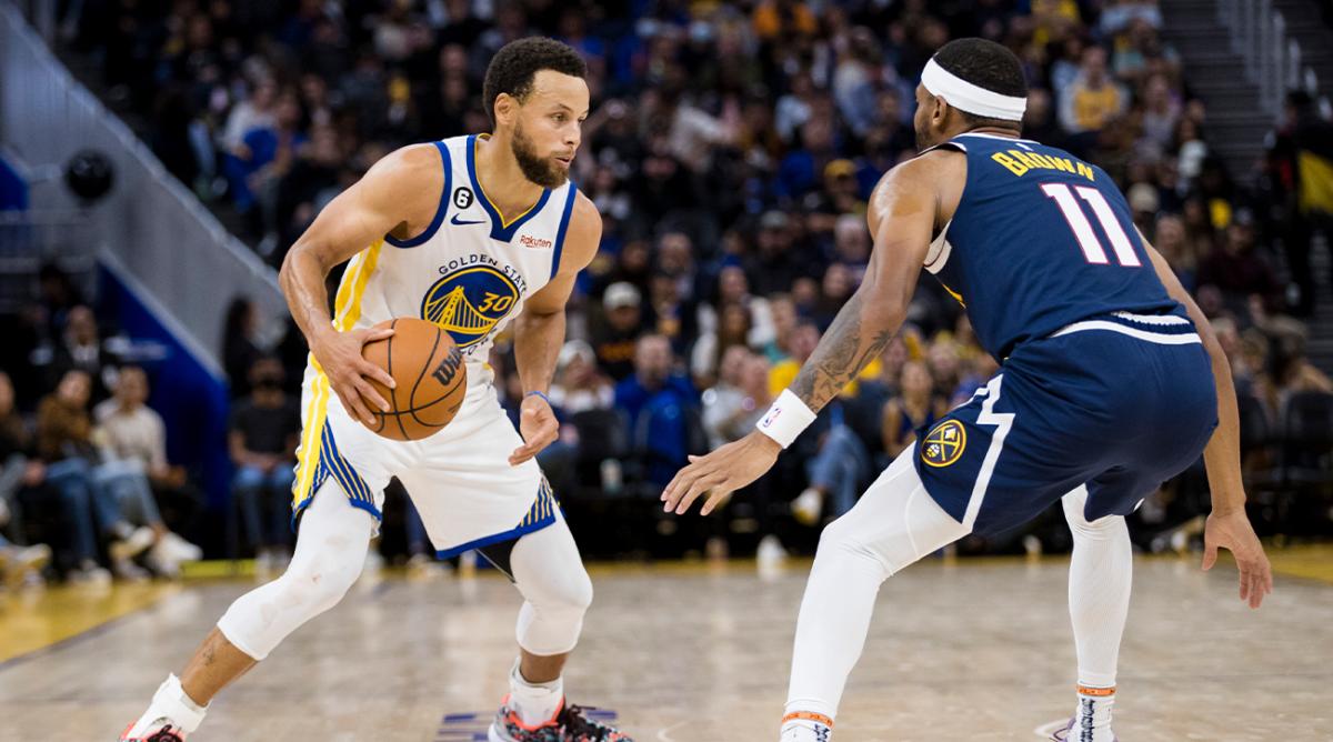 Oct 14, 2022; San Francisco, California, USA; Golden State Warriors guard Stephen Curry (30) dribbles as Denver Nuggets forward Bruce Brown (11) defends during the second half at Chase Center.