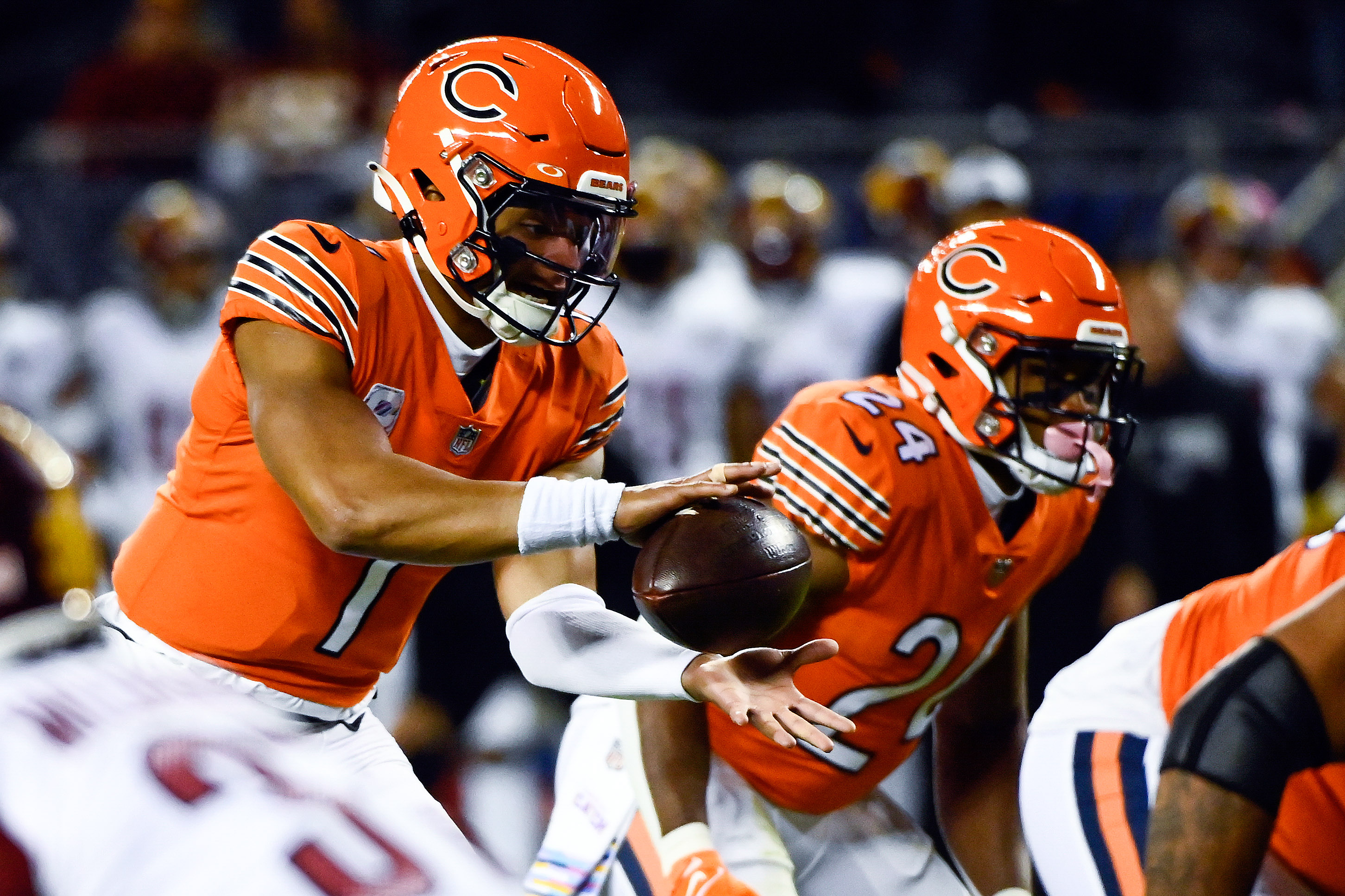 Justin Fields Chicago Bears Unsigned Throwing in Orange Alternate Uniform Photograph