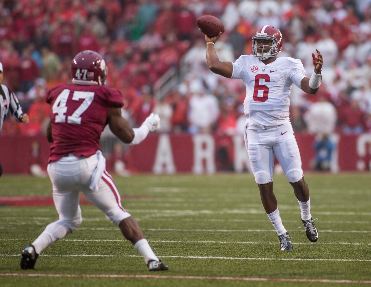 Alabama Crimson Tide quarterback Blake Sims (6) makes a pass under pressure from Arkansas Razorbacks linebacker Martrell Spaight (47) during a game at Donald W. Reynolds Razorback Stadium.