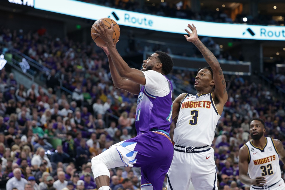 Utah Jazz guard Mike Conley (11) tries to put the ball in the basket after getting past Denver Nuggets guard Bones Hyland (3) during the second half at Vivint Arena.