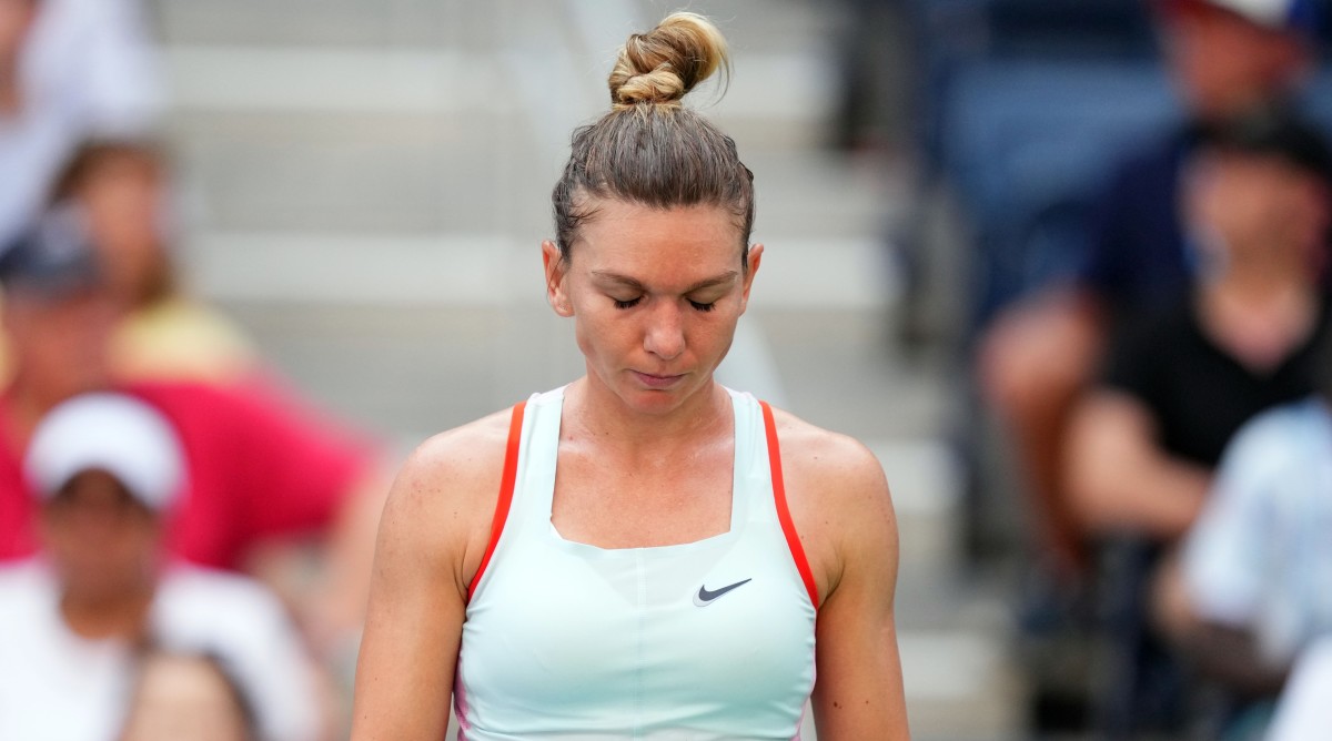 Tennis player Simona Halep looks down at the ground during a match against Daria Snigur at the 2022 U.S. Open.