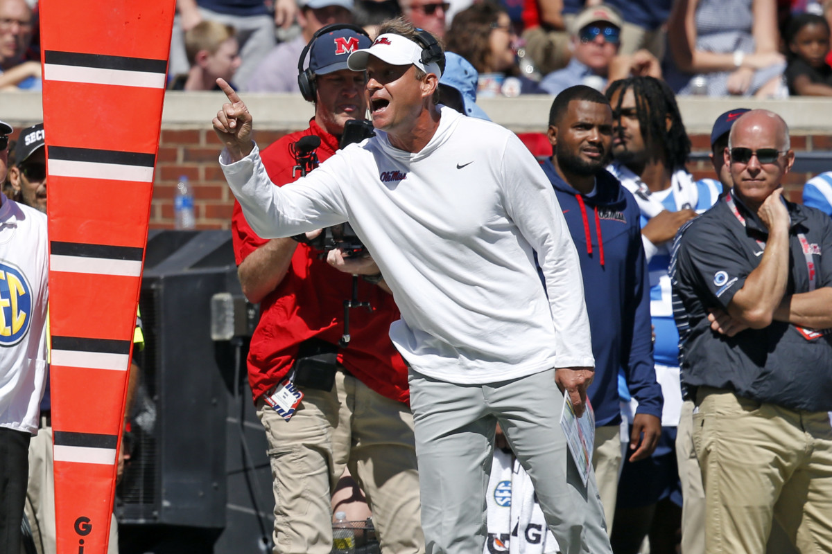 Mississippi Rebels head coach Lane Kiffin talks with a referee during the first half against the Kentucky Wildcats at Vaught-Hemingway Stadium.