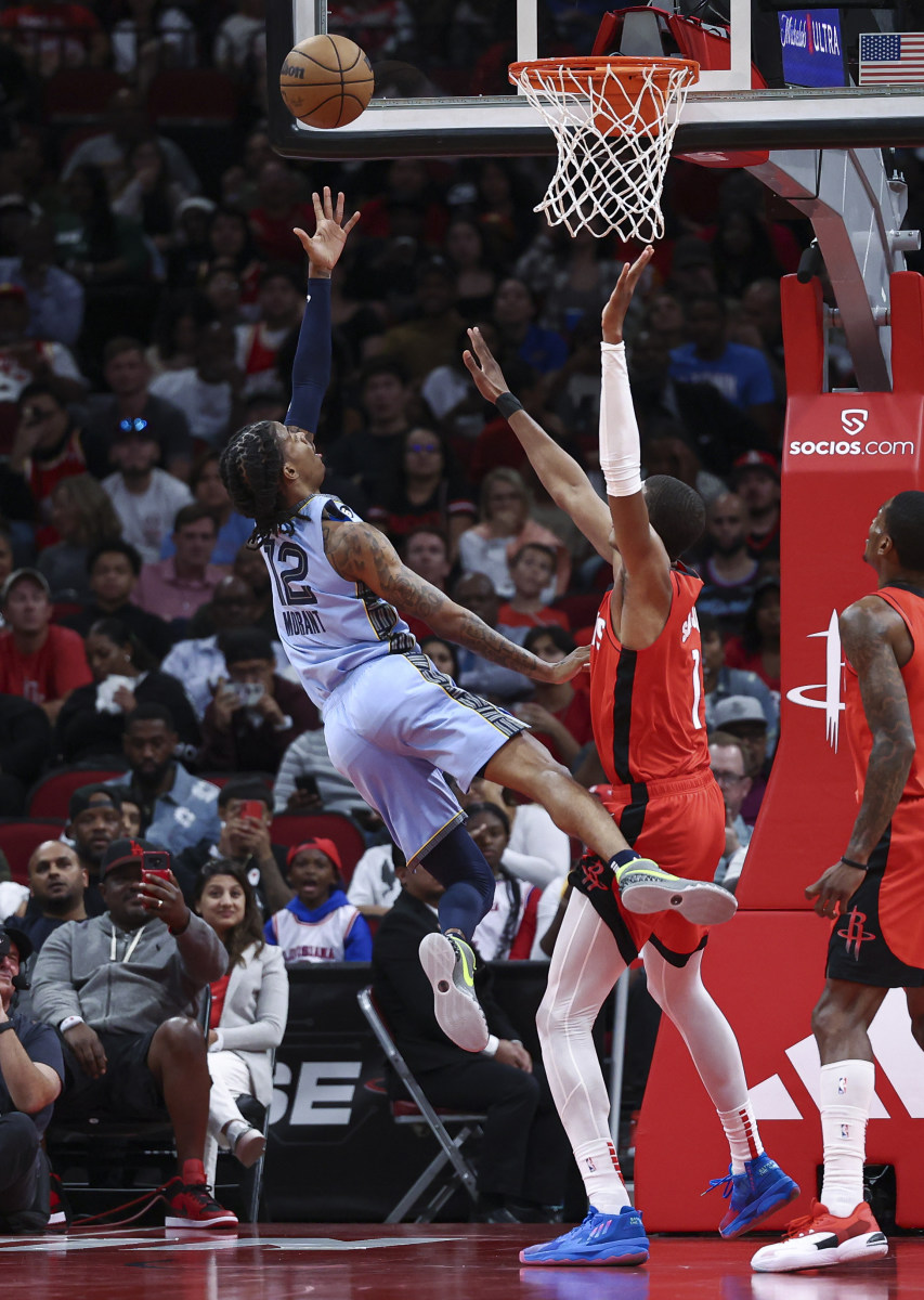 Oct 21, 2022; Houston, Texas, USA; Memphis Grizzlies guard Ja Morant (12) shoots the ball as Houston Rockets forward Jabari Smith Jr. (1) defends during the third quarter at Toyota Center. Mandatory Credit: Troy Taormina-USA TODAY Sports