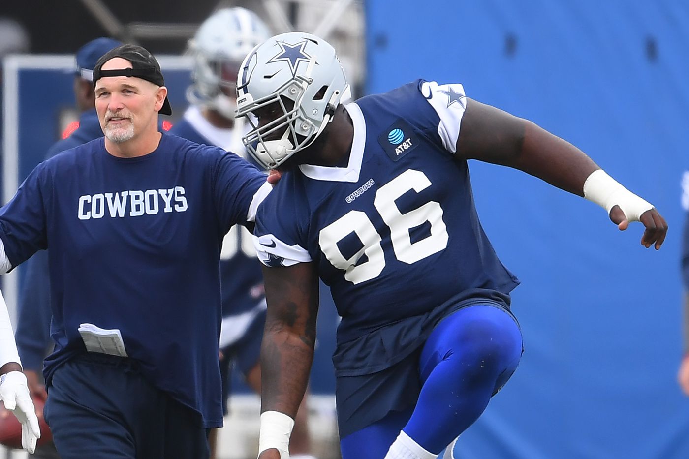 Dallas Cowboys' Micah Parsons (11) and Neville Gallimore leave the