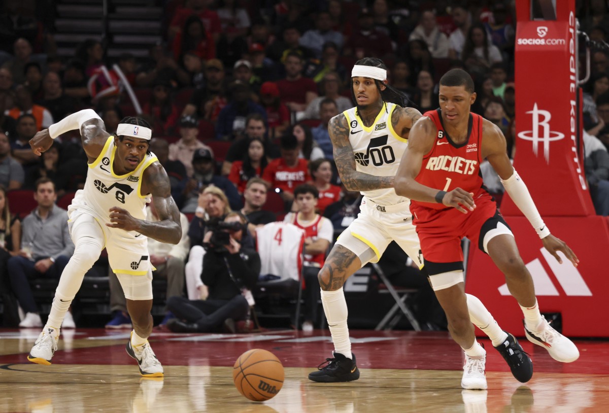 Utah Jazz forward Jarred Vanderbilt (8) and Houston Rockets forward Jabari Smith Jr. (1) run toward a loose ball in the second quarter at Toyota Center.