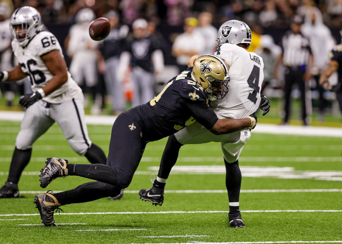 New Orleans Saints defensive end Cameron Jordan (94) hits Las Vegas Raiders quarterback Derek Carr (4) just as he gets rid of the football. Mandatory Credit: Stephen Lew-USA TODAY Sports