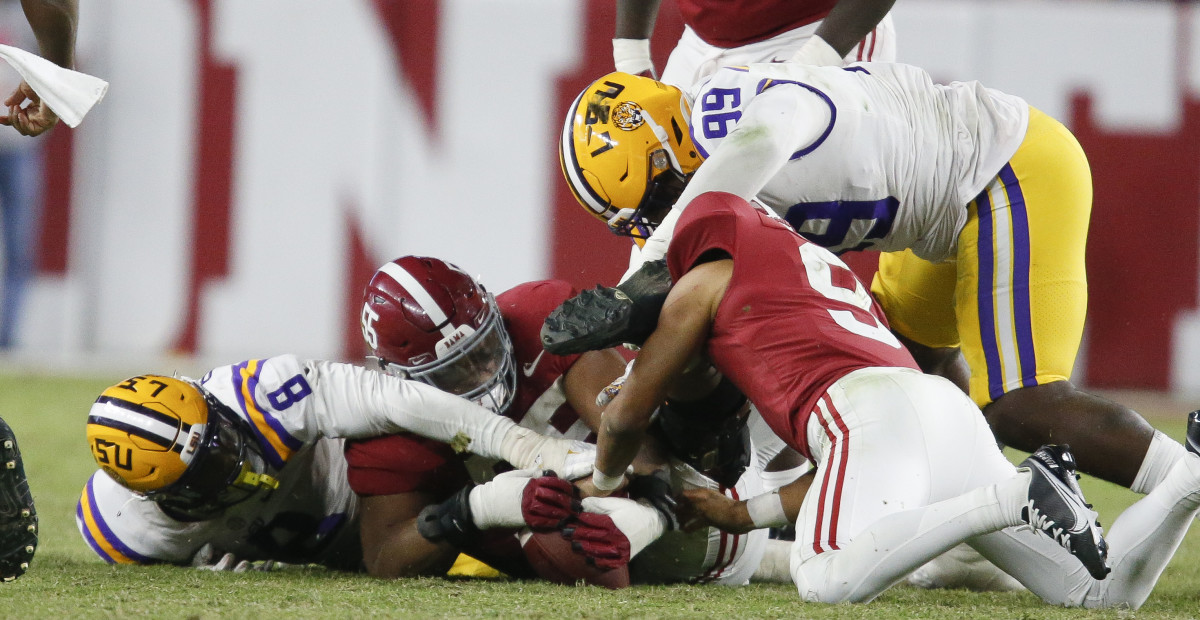 LSU Tigers defensive lineman Jaquelin Roy (99) and defensive end BJ Ojulari (8) battle for a fumble by Alabama Crimson Tide quarterback Bryce Young (9) at Bryant-Denny Stadium. Alabama won 20-14.