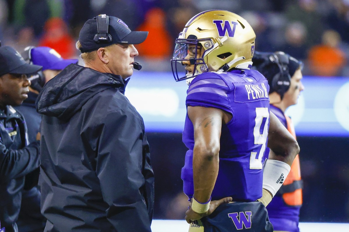 UW coach Kalen DeBoer and quarterback Michael Penix Jr. confer on the sideline.