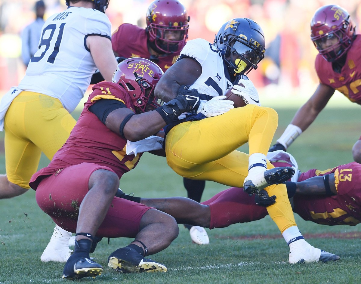 Iowa State Cyclones defensive lineman Tyler Onyedim (11) takes down West Virginia Mountaineers running back Justin Johnson Jr. (26) during the third quarter in the Big-12 showdown at Jack Trice Stadium Saturday, Nov. 5. 2022, in Ames, Iowa. Ncaa Football Baylor At Iowa State