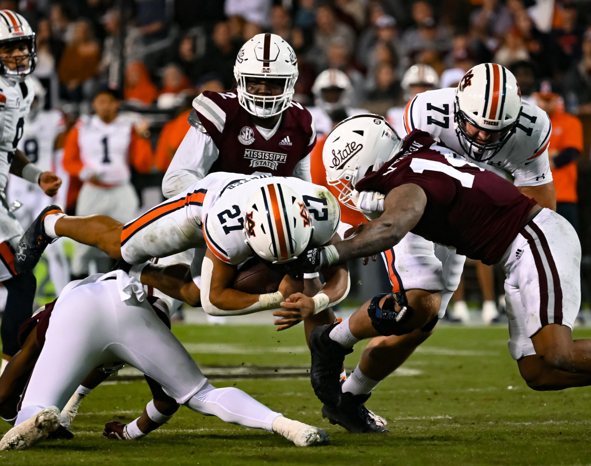 Nov 5, 2022; Starkville, MS, USA; Jarquez Hunter (27) dives over MSU defense during the game between Auburn and Mississippi State at Davis Wade Stadium . Todd Van Emst / AU Athletics