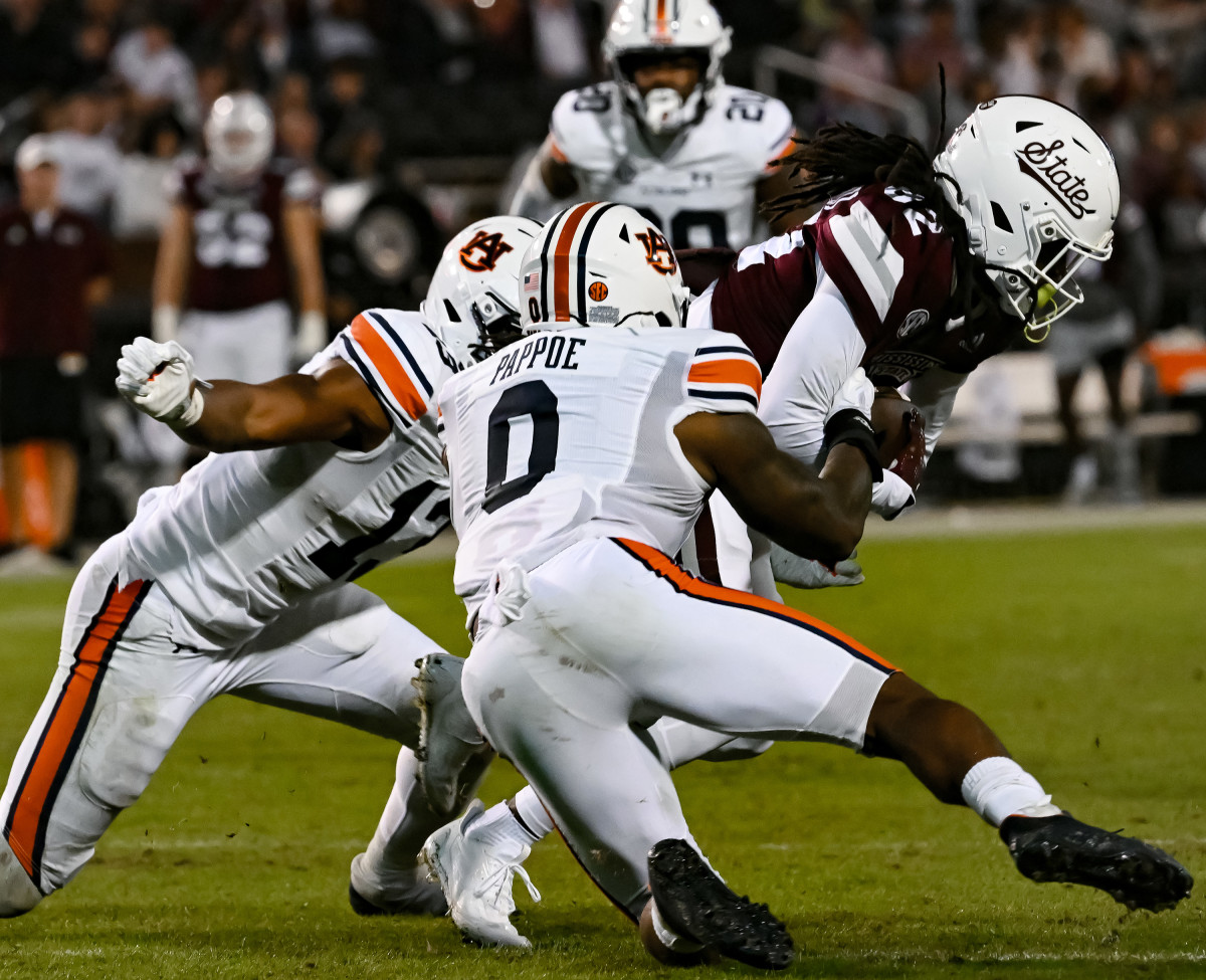 Nov 5, 2022; Starkville, MS, USA; Owen Pappoe (0) and Cam Riley (13) tackle MSU offense between Auburn and Mississippi State at Davis Wade Stadium . Todd Van Emst / AU Athletics