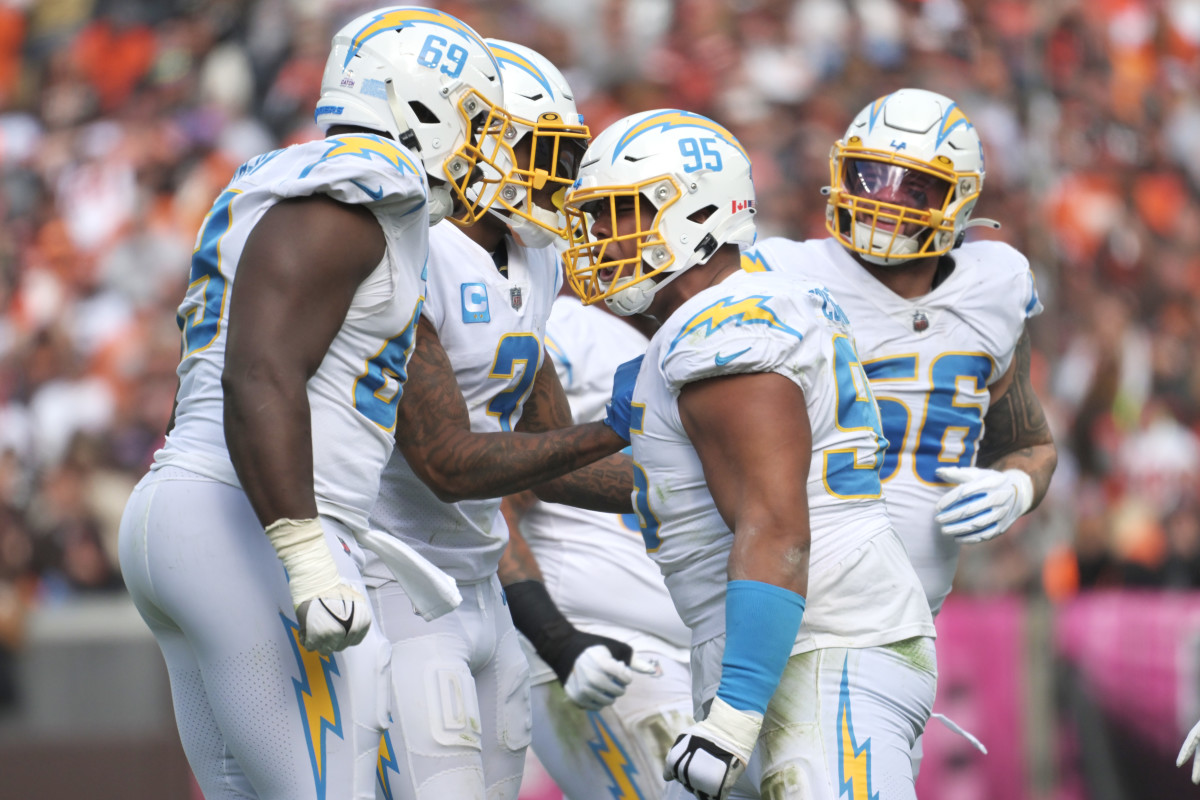 Oct 9, 2022; Cleveland, Ohio, USA; Los Angeles Chargers defensive tackle Sebastian Joseph-Day (69) and defensive tackle Christian Covington (95) celebrate after a fourth down stop during the second half against the Cleveland Browns at FirstEnergy Stadium. Mandatory Credit: Ken Blaze-USA TODAY Sports