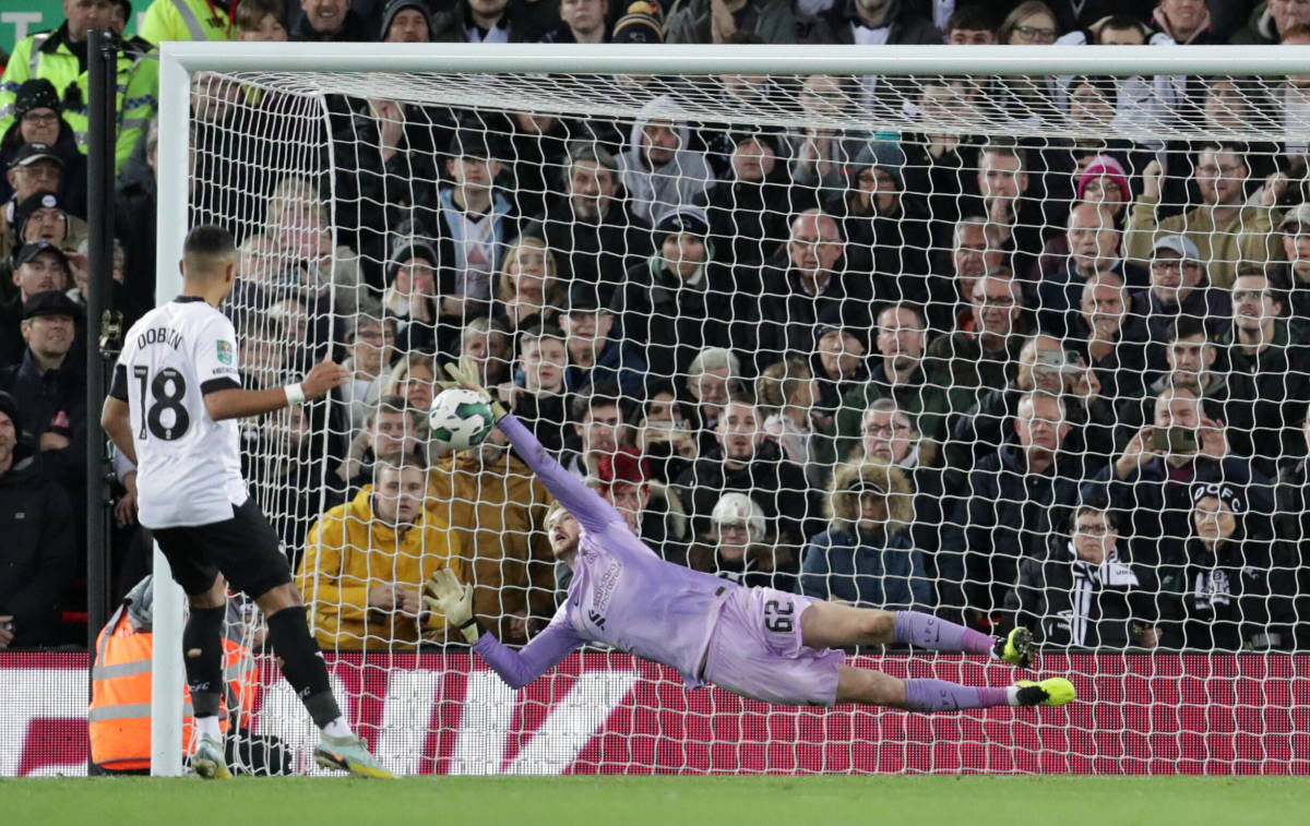 Caoimhin Kelleher pictured saving a penalty kick from Lewis Dobbin during Liverpool's shootout win over Derby in the EFL Cup in November 2022