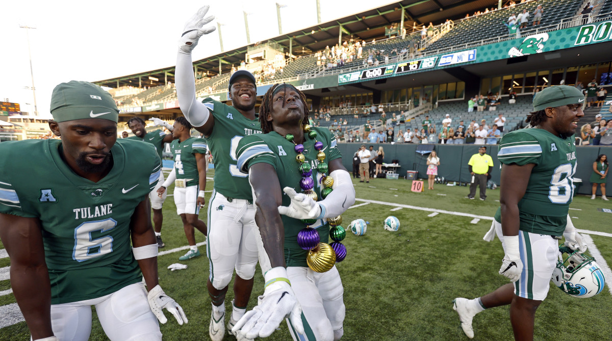 Tulane football players celebrate after a win over Memphis.