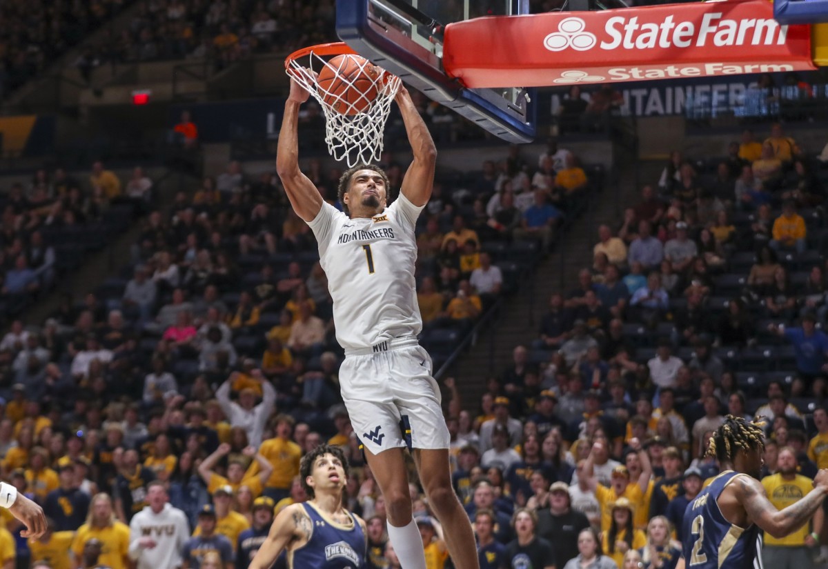 Nov 7, 2022; Morgantown, West Virginia, USA; West Virginia Mountaineers forward Emmitt Matthews Jr. (1) dunks the ball during the second half against the Mount St. Mary's Mountaineers at WVU Coliseum.