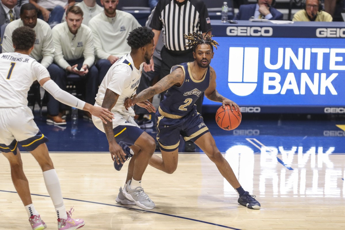 Nov 7, 2022; Morgantown, West Virginia, USA; Mount St. Mary's Mountaineers guard Deandre Thomas (2) dribbles against West Virginia Mountaineers guard Kobe Johnson (2) during the first half at WVU Coliseum.