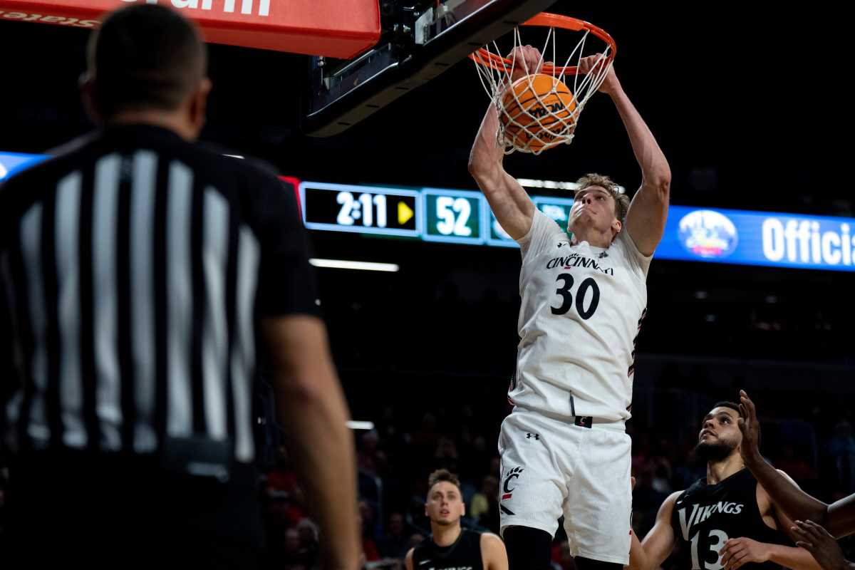 Cincinnati Bearcats forward Viktor Lakhin (30) dunks as Cleveland State Vikings forward Tristan Enaruna (13) looks on in the second half of the men s NCAA basketball game at Fifth Third Arena in Cincinnati on Thursday, Nov. 10, 2022. Cincinnati Bearcats defeated Cleveland State Vikings 69-58. Cleveland State Vikings At Cincinnati Bearcats