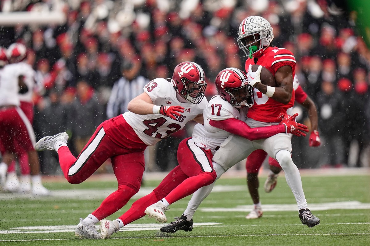 Indiana Hoosiers linebacker Matt Hohlt (43) and defensive back Jonathan Haynes (17) tackle Ohio State Buckeyes wide receiver Marvin Harrison Jr. (18) during the first half of the NCAA football game at Ohio Stadium.