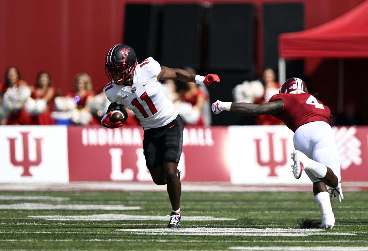 Sep 17, 2022; Bloomington, Indiana, USA; Western Kentucky Hilltoppers wide receiver Malachi Corley (11) evades tackle from Indiana Hoosiers linebacker Cam Jones (4) during the first quarter at Memorial Stadium. Mandatory Credit: Marc Lebryk-USA TODAY Sports