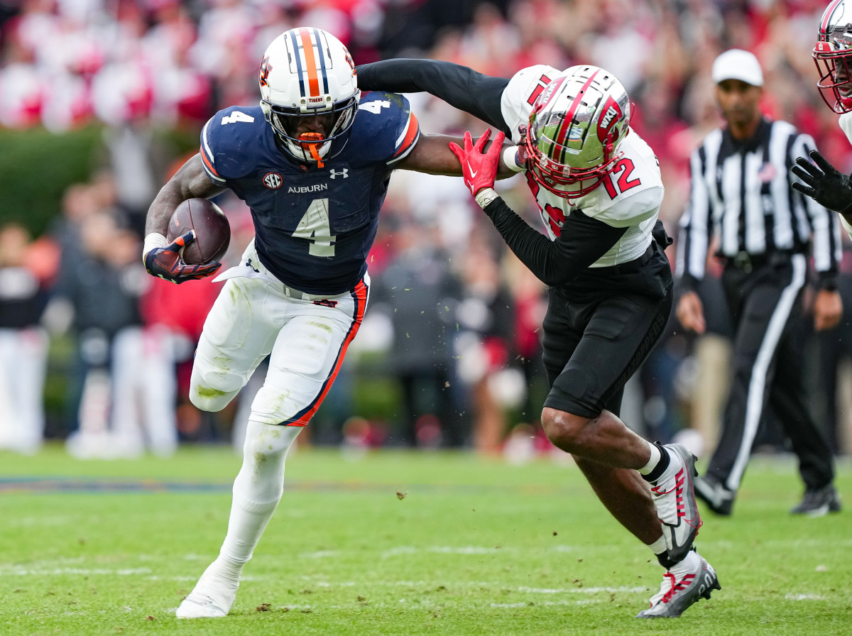 Tank Bigsby (4) stiff arms defender during the game between Auburn and Western Kentucky at Jordan-Hare Stadium. Austin Perrymann/AU Athletics