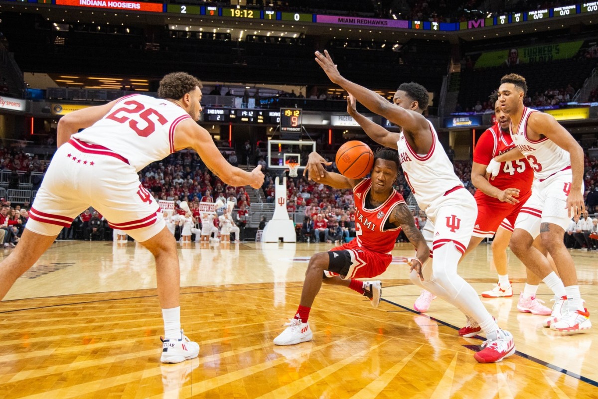 Race Thompson, Xavier Johnson and Trayce Jackson-Davis defend.