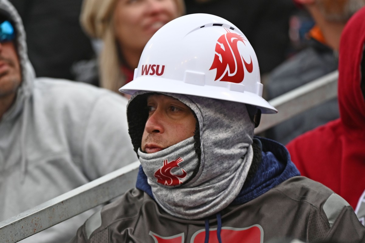 A Cougar fans comes in his hard hat and layers of clothing to watch WSU play.