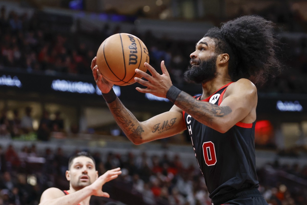 Chicago Bulls guard Coby White (0) drives to the basket against the Toronto Raptors during the second half at United Center. 